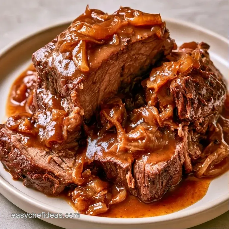 Elegant slices of roasted beef drizzled with glossy onion gravy on a white platter, garnished with fresh thyme.